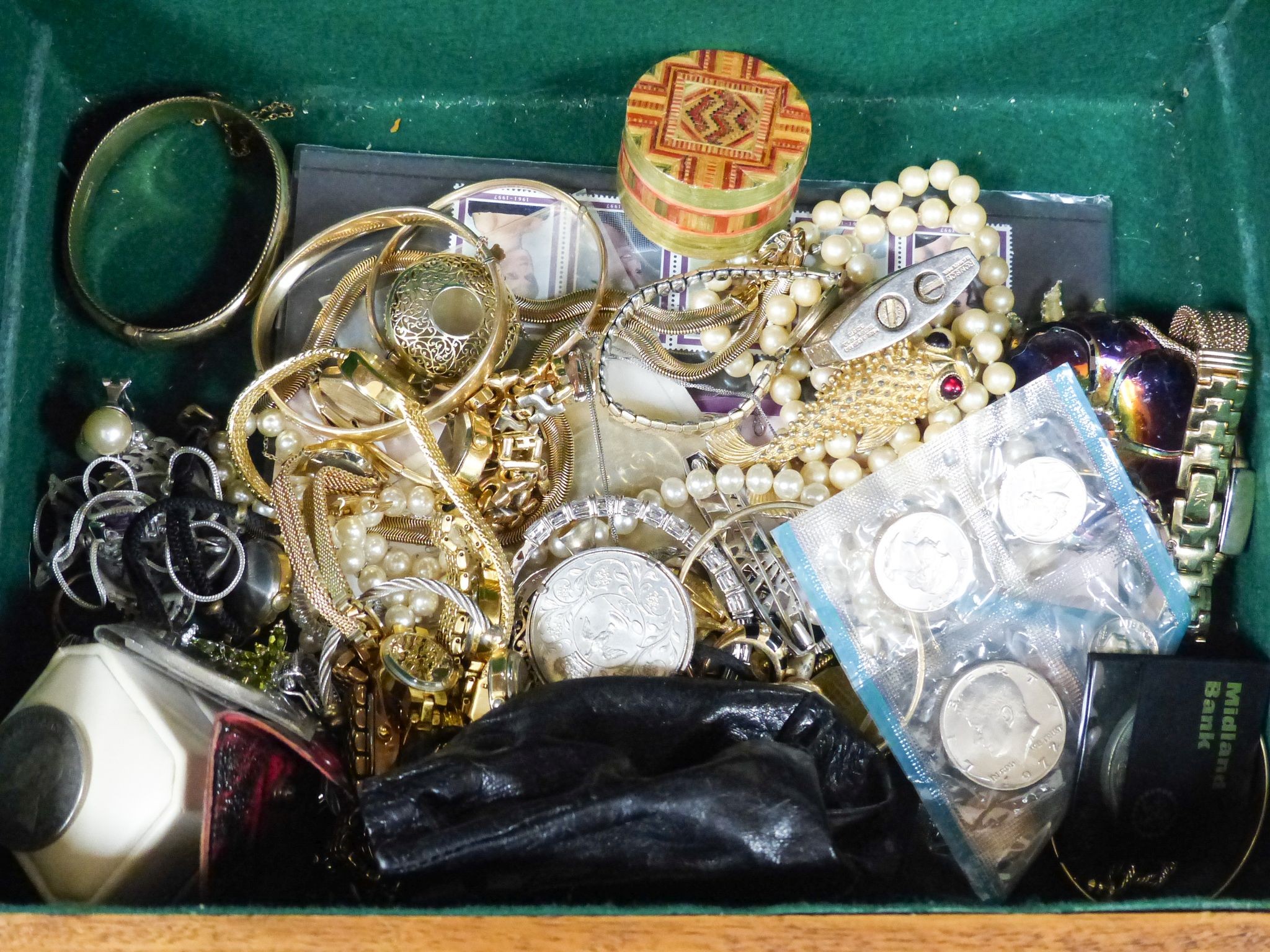 A quantity of assorted costume jewellery and coins etc. in a walnut box.